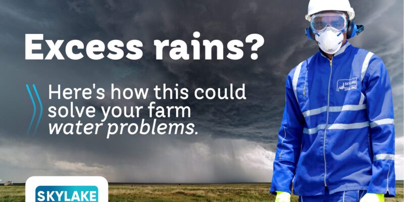 Skylake Drilling technician in protective gear standing in a field under heavy rain clouds, representing farm water management solutions during excess rainfall.